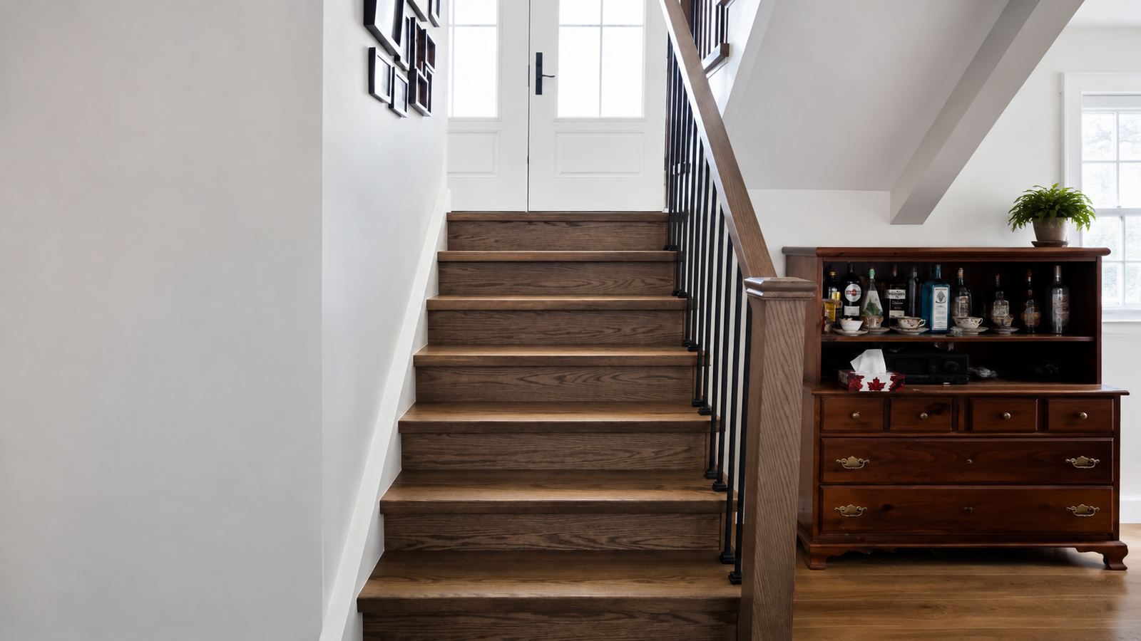 Modern Red Oak Staircase Renovation with Black Iron Spindles in Stayner